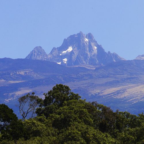Mount Kenya hiking adventure with trekkers ascending towards Point Lenana summit at sunrise