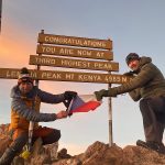 Mount Kenya Point Lenana summit at sunrise with hikers celebrating the achievement