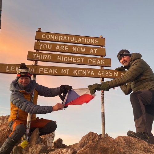 Mount Kenya Point Lenana summit at sunrise with hikers celebrating the achievement