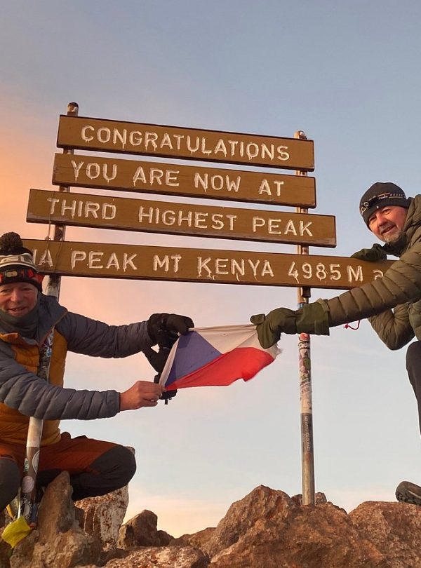 Mount Kenya Point Lenana summit at sunrise with hikers celebrating the achievement