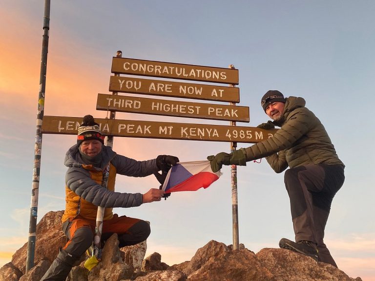 Mount Kenya Point Lenana summit at sunrise with hikers celebrating the achievement