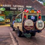 A customized safari jeep parked at the main entrance of Nairobi National Park ready for a wildlife safari adventure.