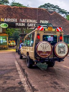 A customized safari jeep parked at the main entrance of Nairobi National Park ready for a wildlife safari adventure.