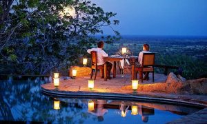 Couple on Honeymoon safari Kenya enjoying a luxury safari experience in Kenya with scenic savannah landscapes and wildlife in the background.
