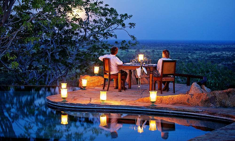 Couple on honeymoon enjoying a luxury safari in Kenya with scenic savannah landscape and wildlife