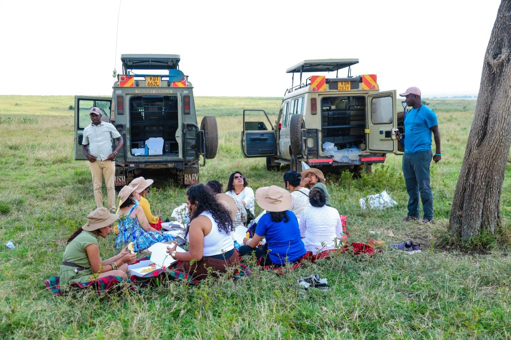 Large family group on safari in Maasai Mara gathered in a 4x4 vehicle watching wildlife on the savannah