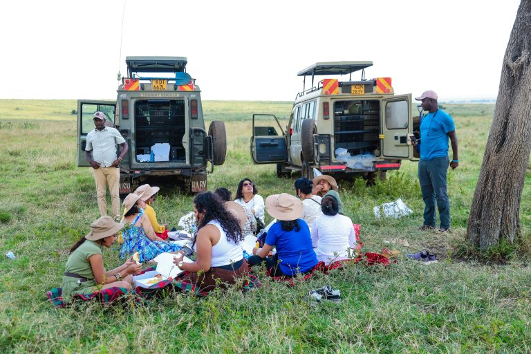 Large family group on safari in Maasai Mara gathered in a 4x4 vehicle watching wildlife on the savannah