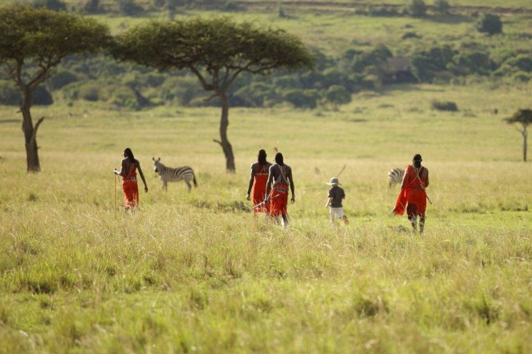 Clients enjoying a Walking Safari Kenya Guide experience in the Laikipia wilderness with a professional safari guide and ranger.