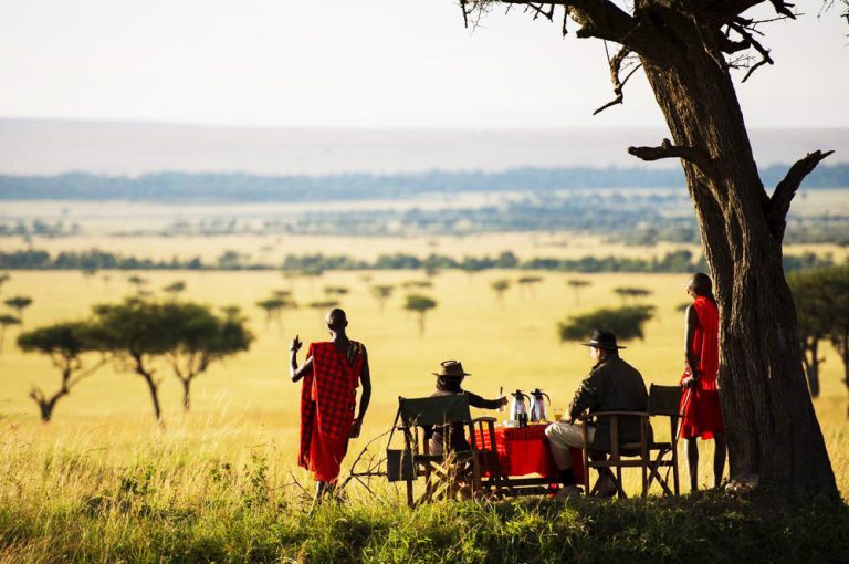 Romantic honeymoon safari in Kenya featuring a luxury lodge, scenic savannah views, and a couple enjoying a private sunset experience in the wild