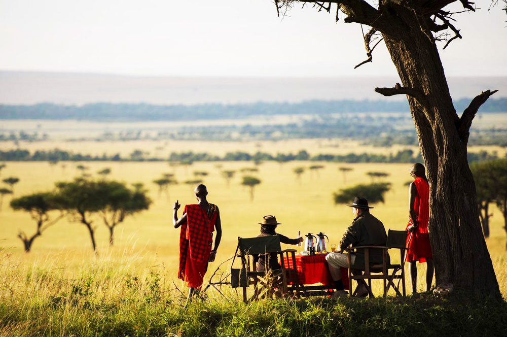Romantic honeymoon safari in Kenya featuring a luxury lodge, scenic savannah views, and a couple enjoying a private sunset experience in the wild