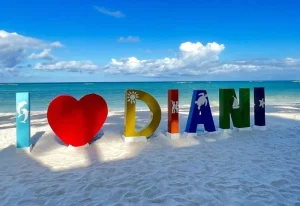 Ultimate Diani Beach Guide — iconic Diani Beach sign surrounded by palm trees and tropical coastal scenery in Diani Beach.