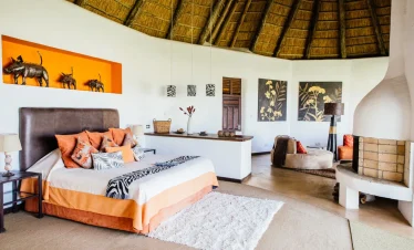 Luxury bedroom suite at Marriott Lodge Solio Conservancy featuring modern interiors, king-sized bed, and views of the surrounding wilderness