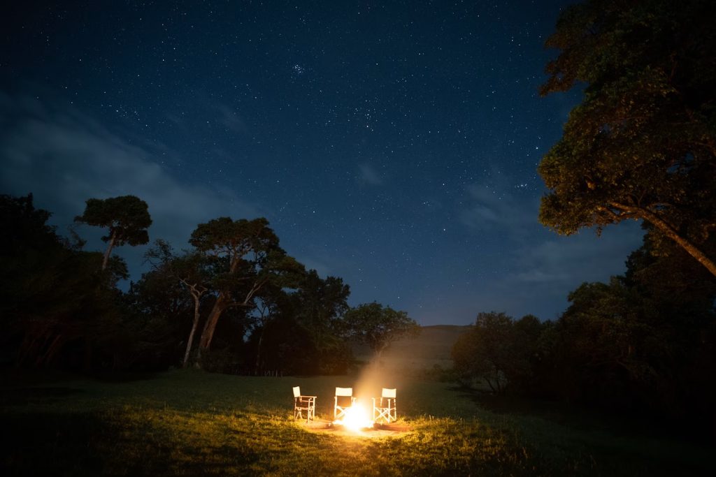 Campfire under a starry sky at a Kenyan safari camp
