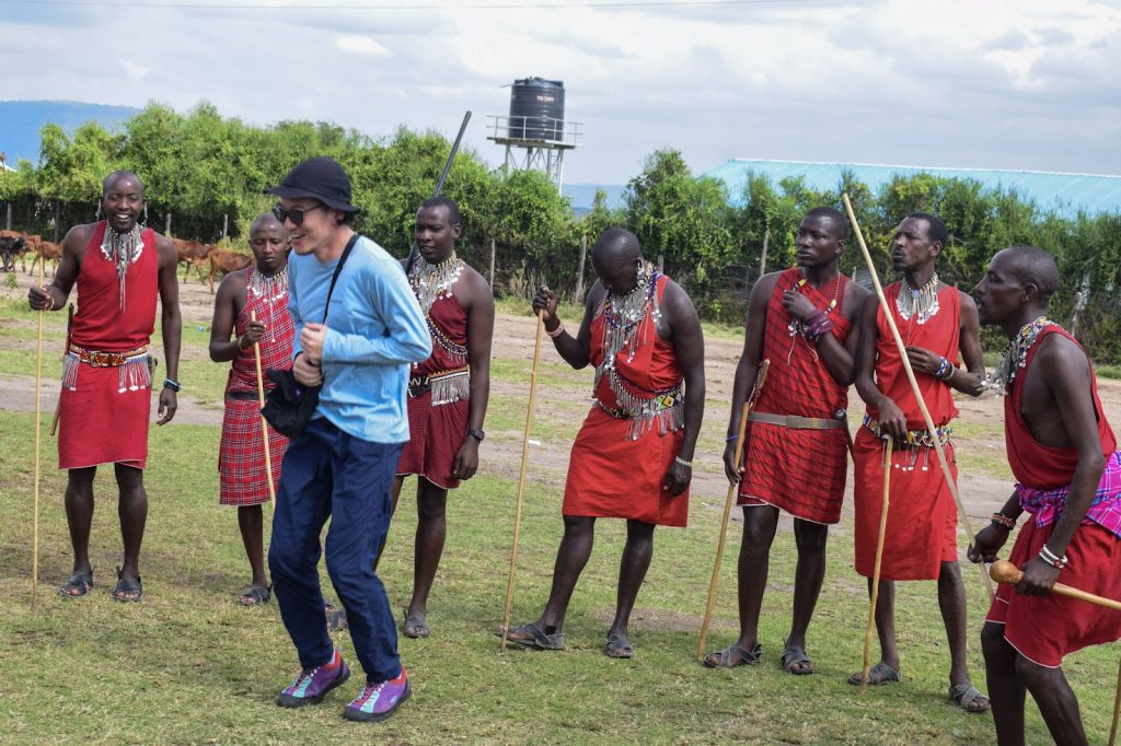 Maasai warriors performing the adumu jumping dance with safari guests