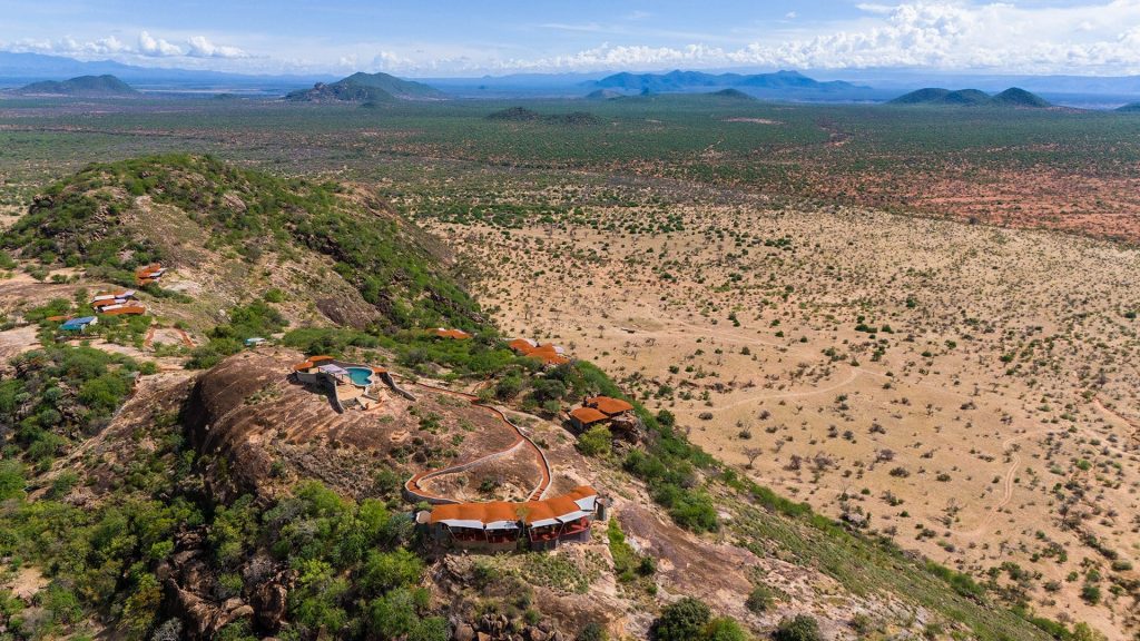 Aerial of Saruni Samburu lodge on a rocky kopje overlooking the Samburu plains
