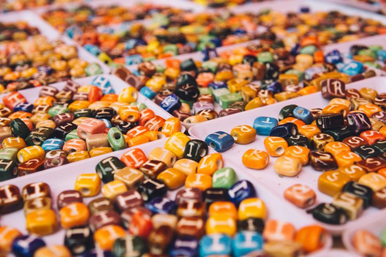 Colourful handmade beads on a tray, like the ceramic beads made at Kobe Tough Beads in Karen