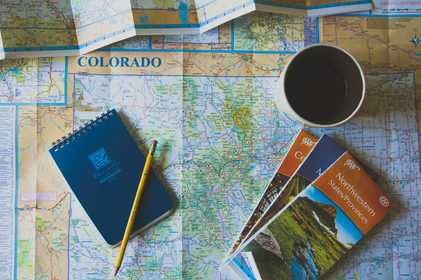 Map, books and a pencil laid out for planning a safari itinerary