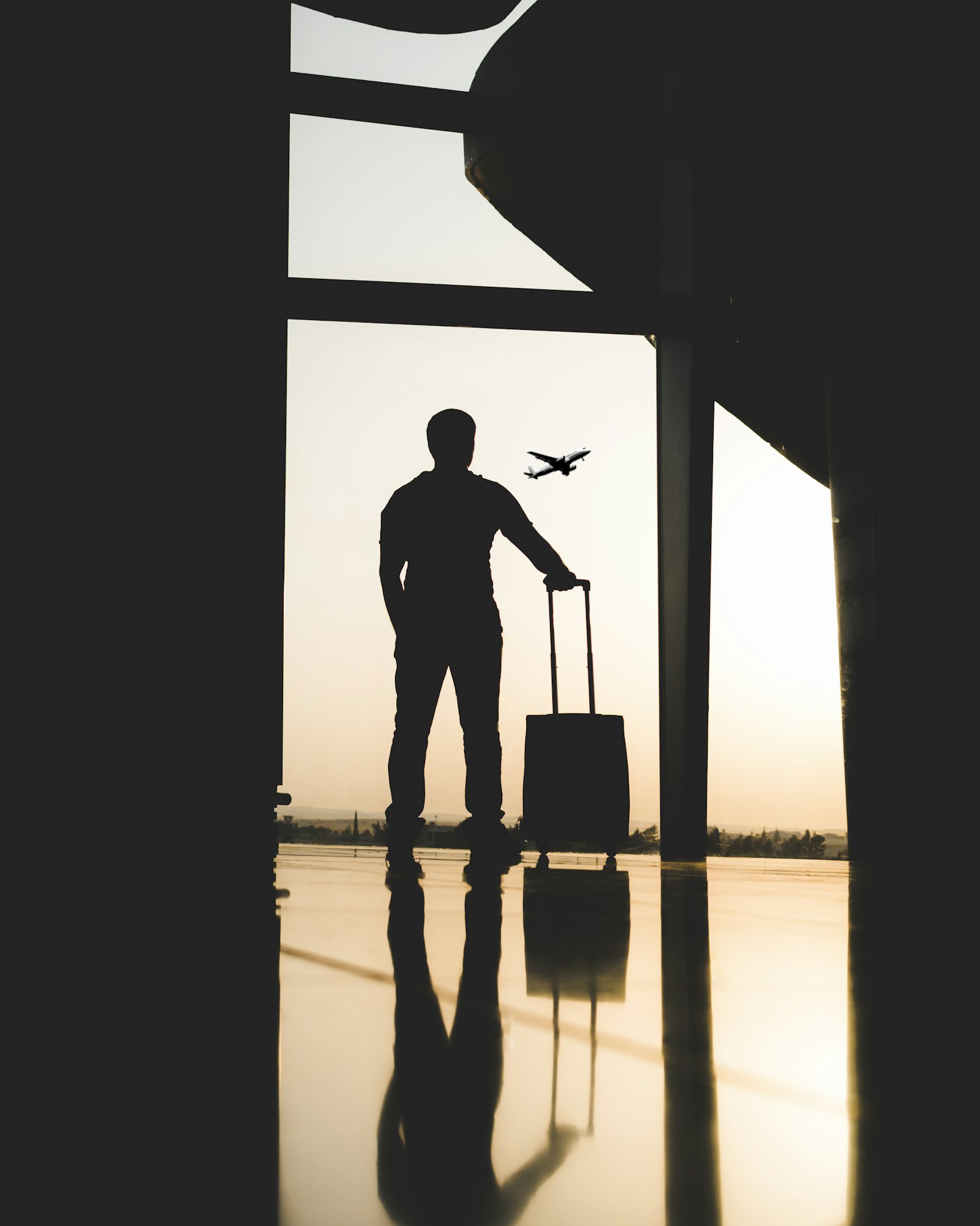 Independent traveller holding luggage inside an airport terminal before a safari