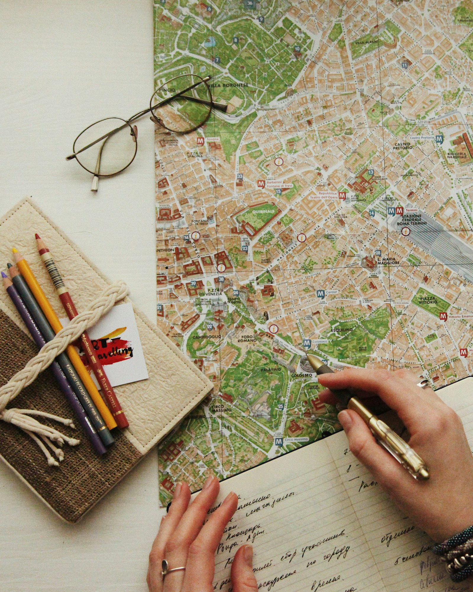 Eyeglasses resting on a map while a travel professional works on safari costing
