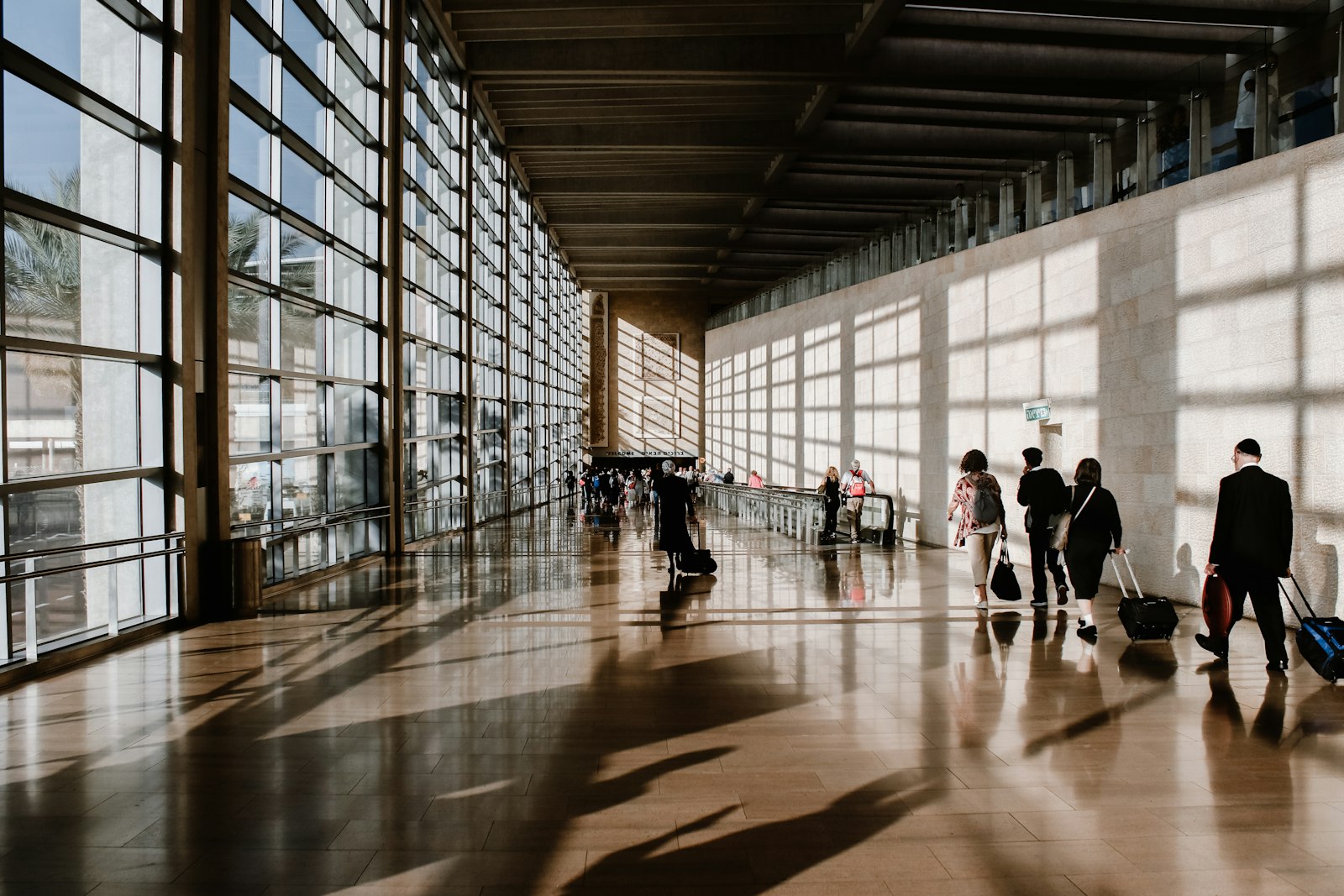 Travellers walking through a sunlit terminal, asking is it safe to leave JKIA on a layover