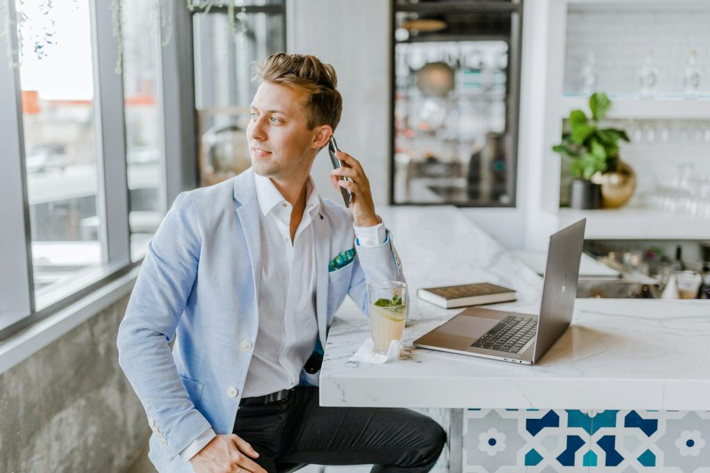 Agent seated at a white table planning how to sell Kenya safaris to clients