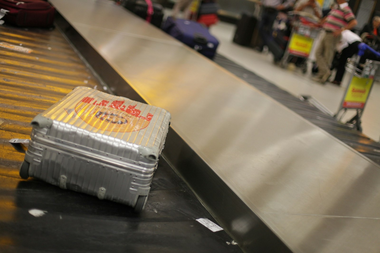 Grey hard-shell suitcase packed and ready for an international flight connection