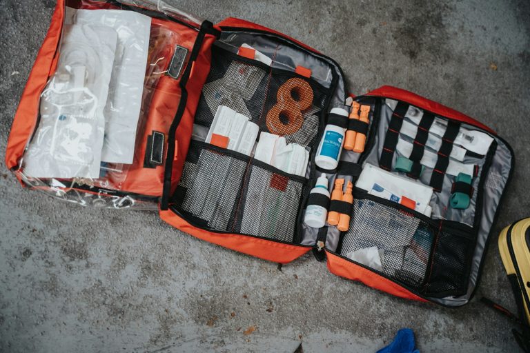 Sick on safari: an open red first aid bag with medical supplies ready for travel