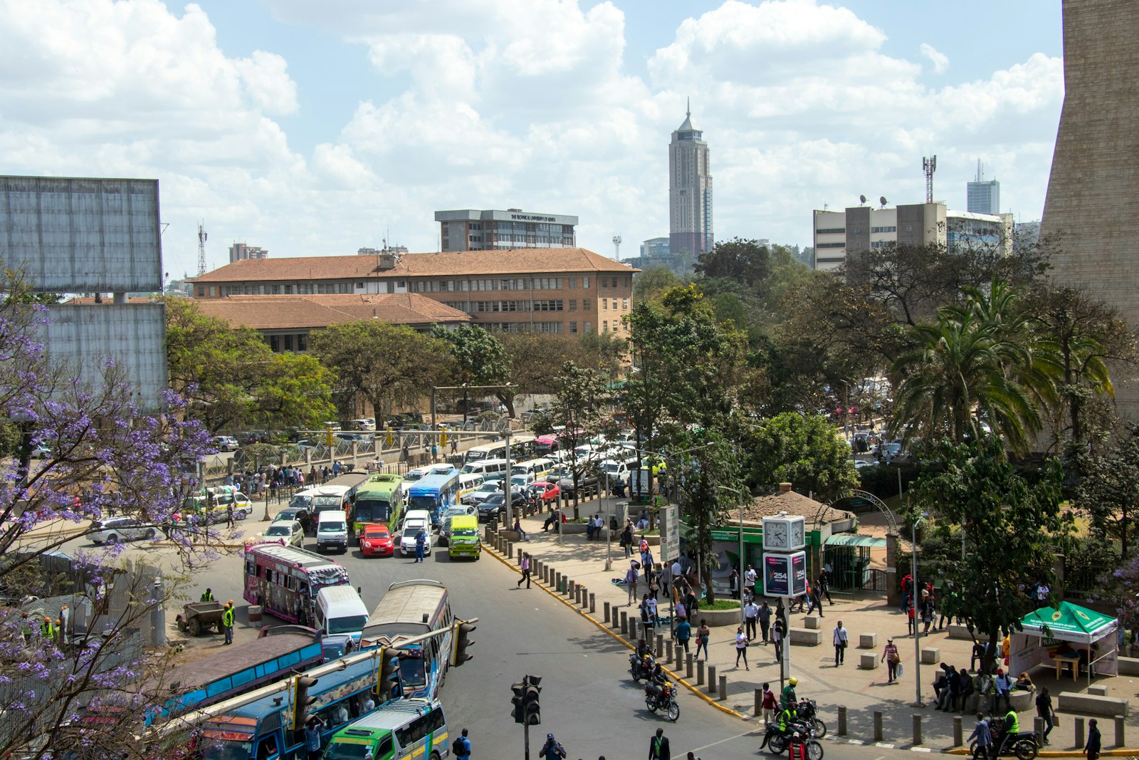 Busy Nairobi street with traffic, buses and pedestrians during the day