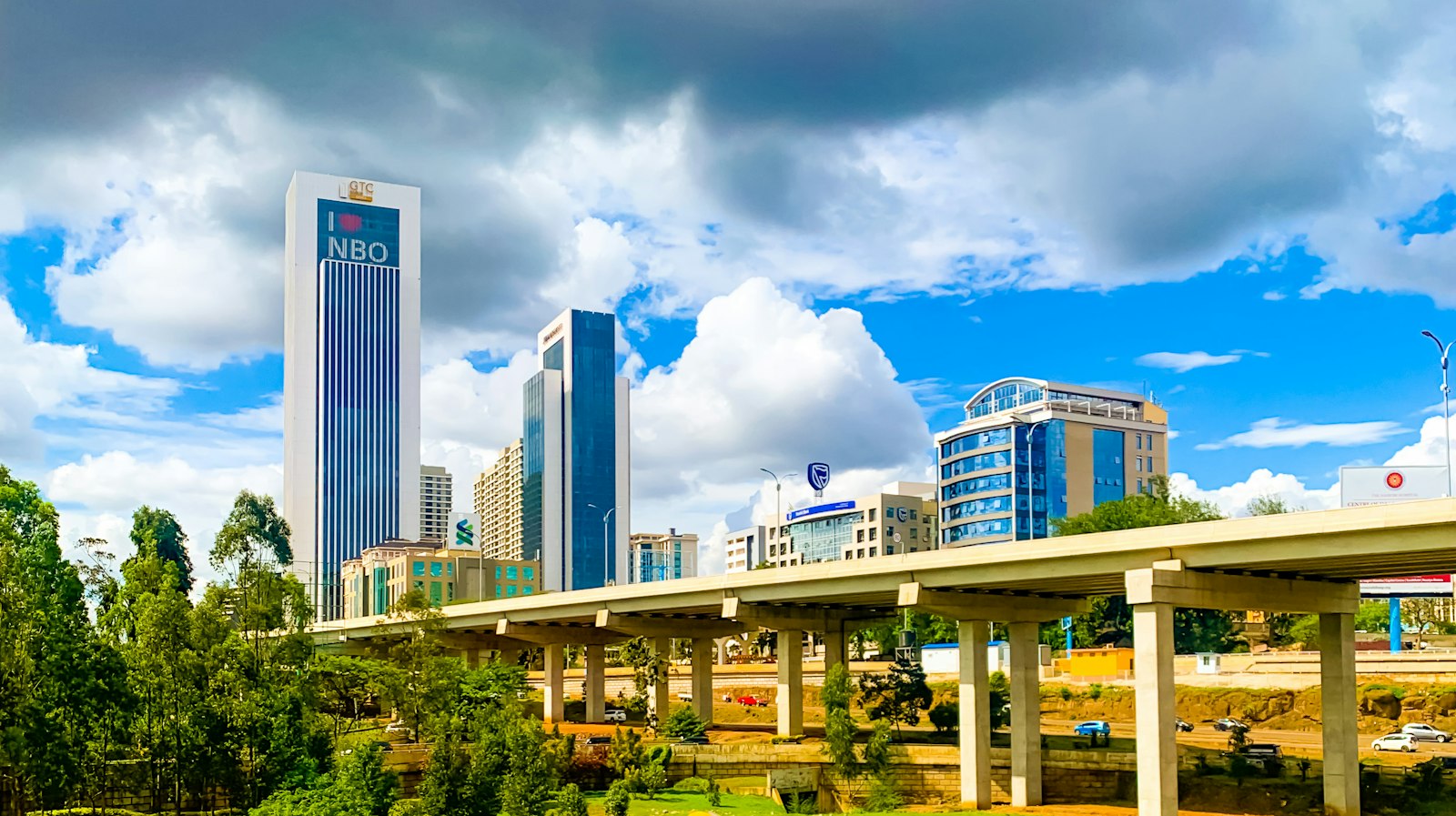 Budget Nairobi layover view of a road bridge and Westlands high-rise towers under cloud