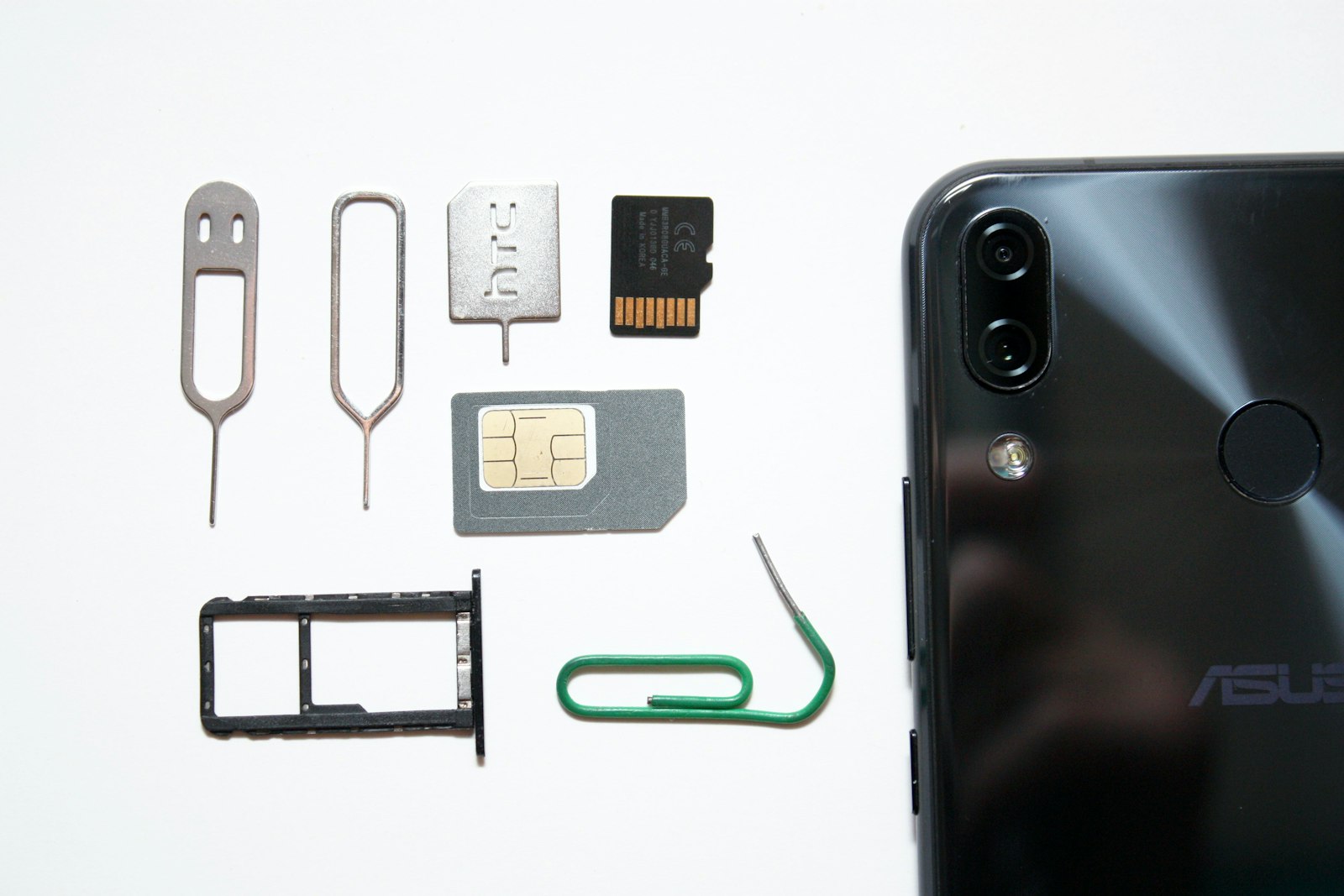 Smartphone with its SIM tray open and a SIM card ready to insert for travel in Kenya