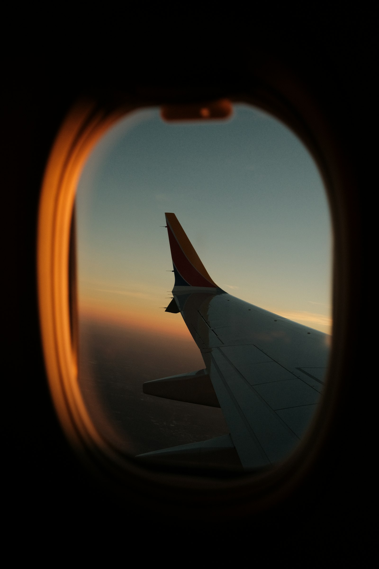 The wing of an aircraft seen through a cabin window before an overnight Nairobi stop