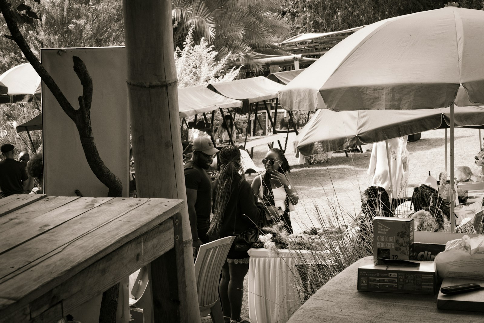 Friends chatting and shopping at an open-air farmers market in Karen, Nairobi, Kenya