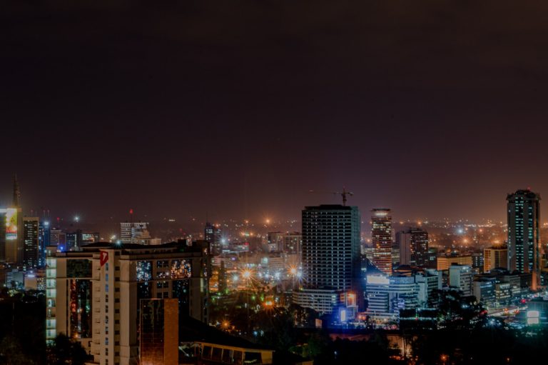 Nairobi layover at night: the city skyline lit up against a dark evening sky