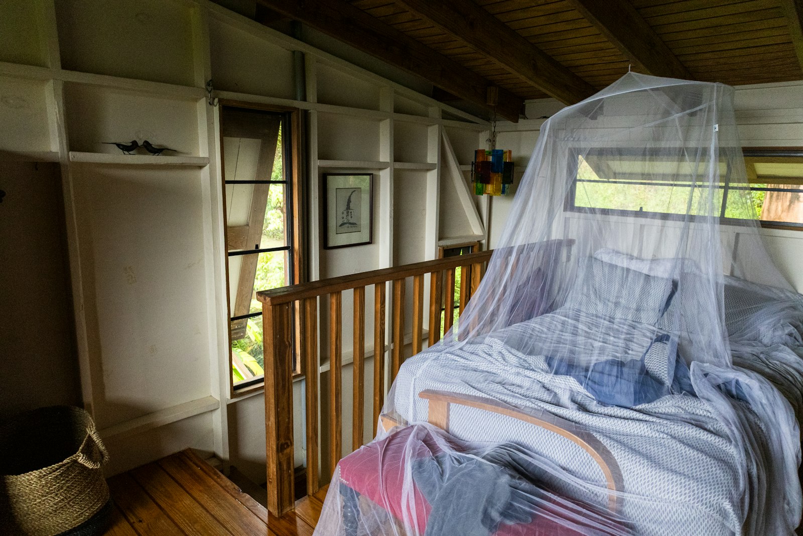 Kenya safari malaria precautions: bed draped with a mosquito net in a cosy room