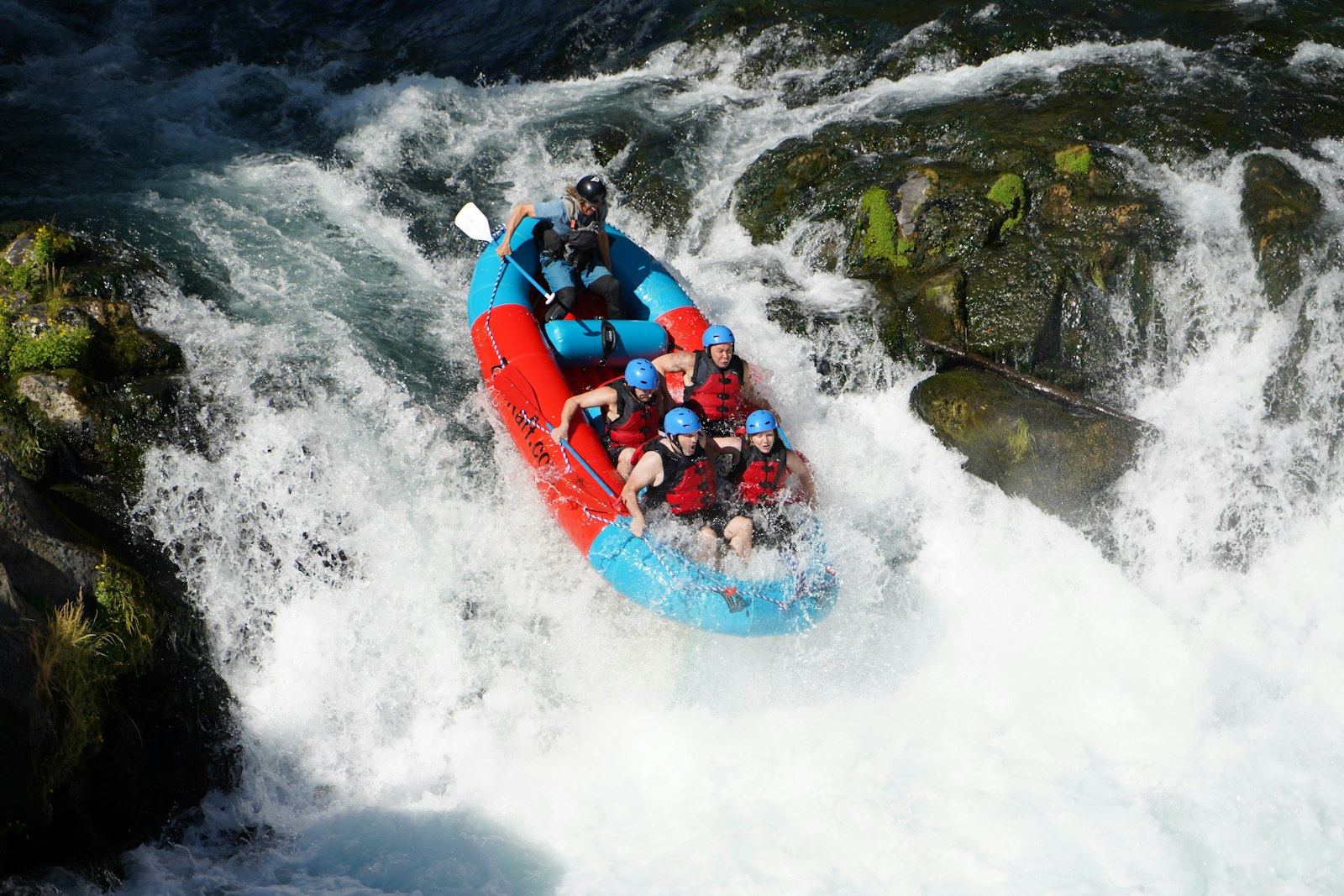 Raft crew paddling through rapids during Sagana white water rafting in Kenya