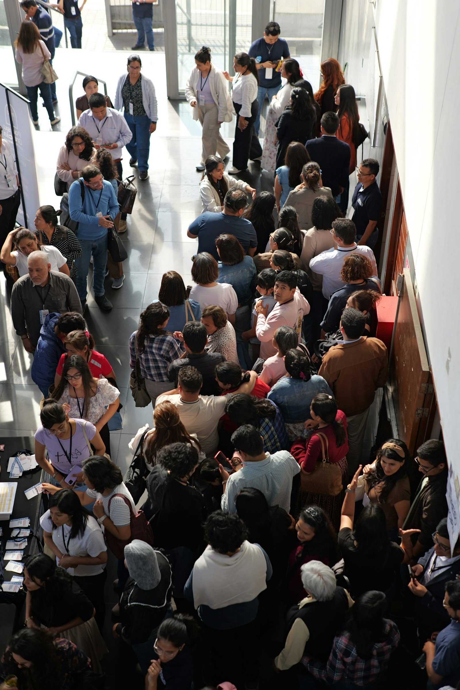 Long queue of travellers inside a building during a large group check-in